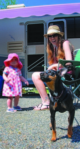 Mother and daughter rest outside their RV Camper parked at Stub Stewart's Camper Park.